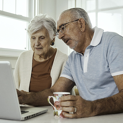 A couple looking at a desktop together