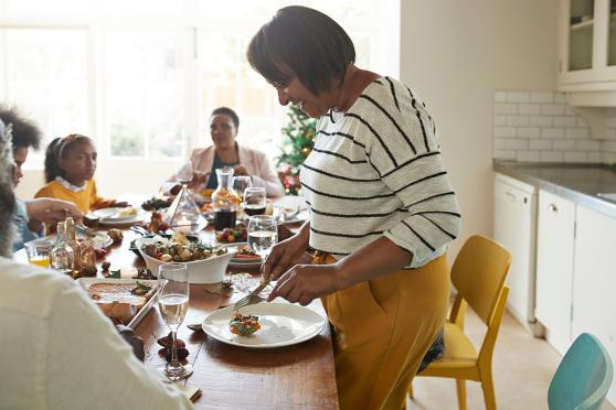 a family eats a meal at a dining room table