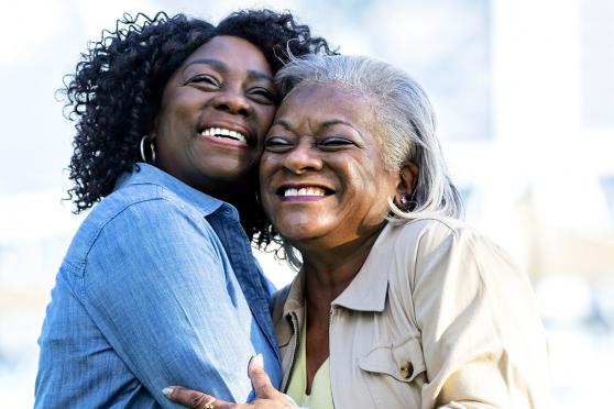 Two women hugging each other and smiling