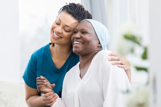 Nurse embracing older woman