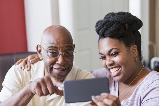 An older couple looks at a smartphone