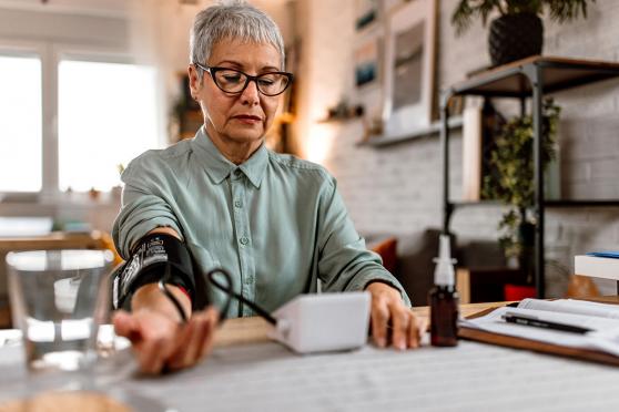 woman using blood pressure monitor 