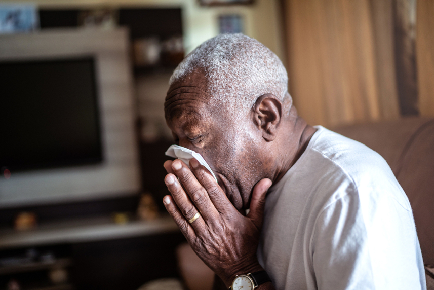 A man blowing his nose.