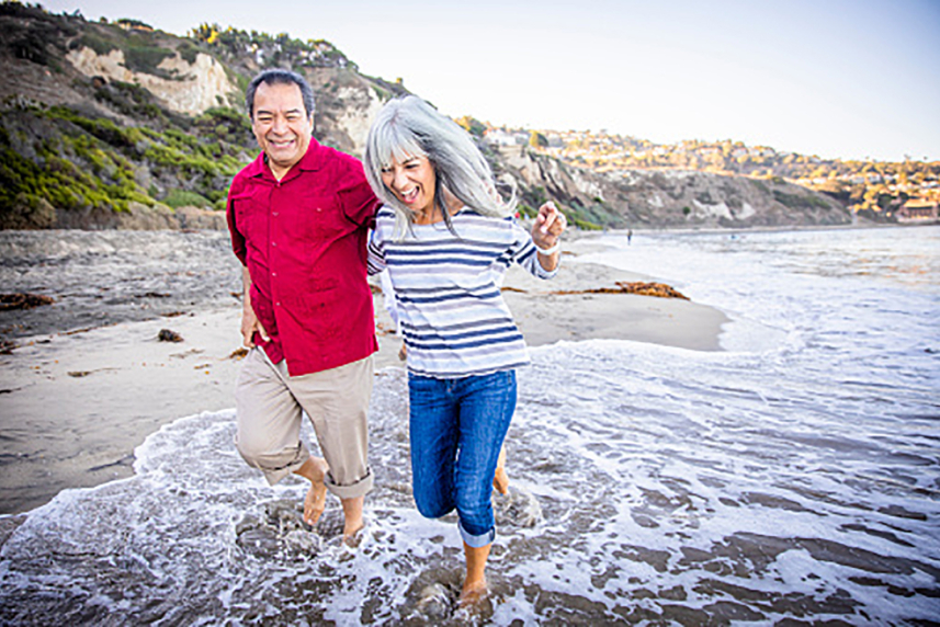 A couple walking on the beach.