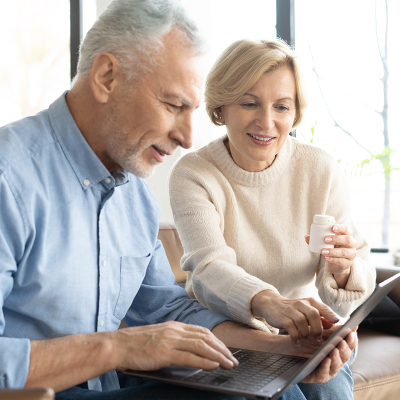 A senior couple working together on a laptop