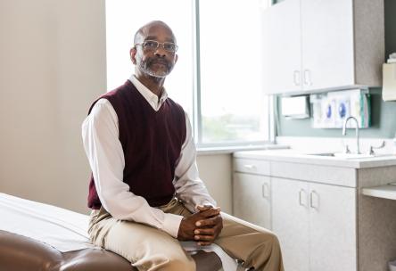 Man waiting for doctor in exam room