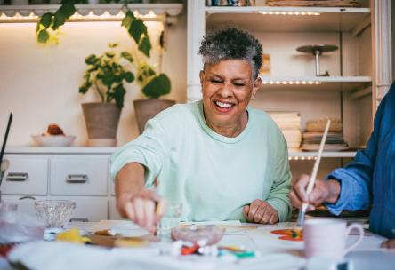 An older woman works on a craft project