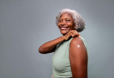 A woman with a bandage on her arm.