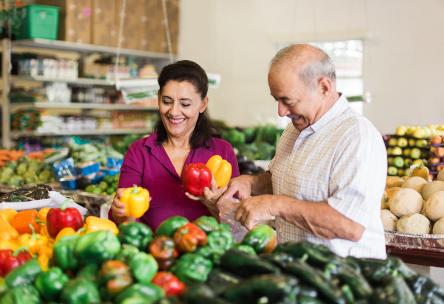 An older couple shops for groceries