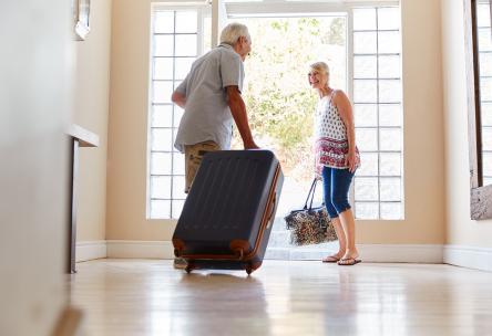 Senior couple getting ready to travel with luggage