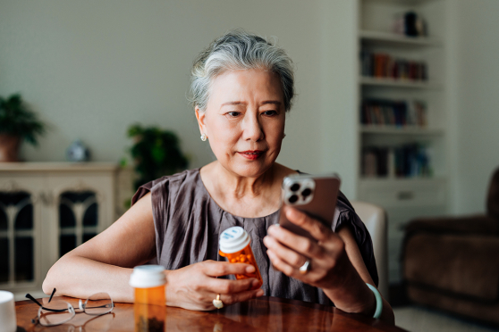 woman looking at prescription bottle