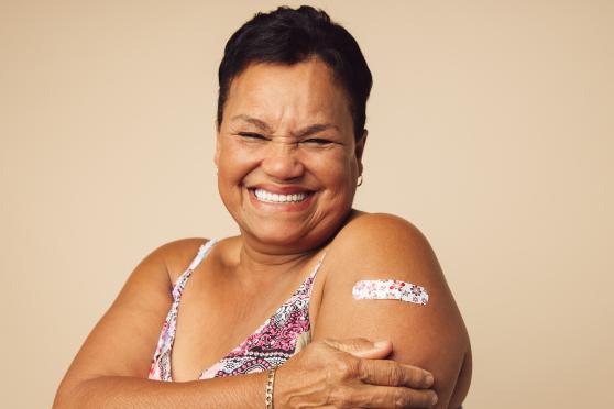 A woman with a bandage on her arm.