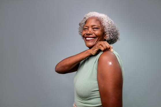 A woman with a bandage on her arm