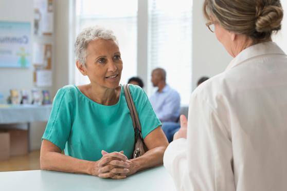 A woman talking to a doctor.