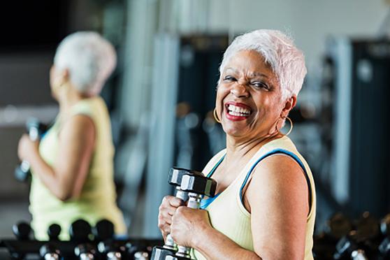A woman holding dumbbells. 
