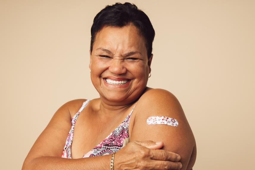 A woman with a bandage on her arm
