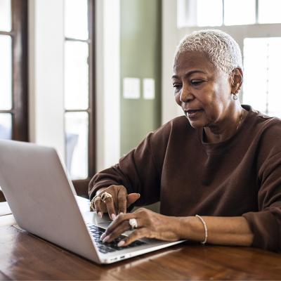 An older woman checking her laptop