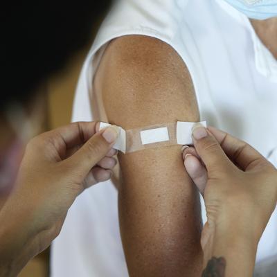 A band-aid being put on over a flu shot