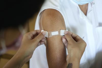 A band-aid being put on over a flu shot
