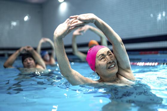 Woman doing water aerobics in workout class